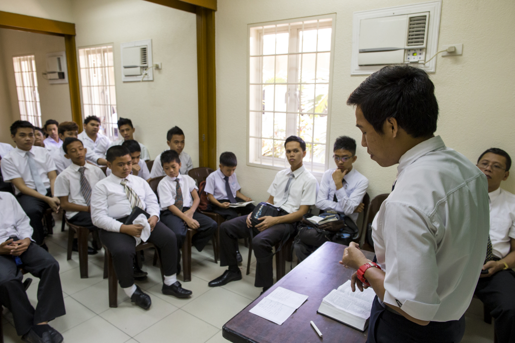 Young man teaching in a priesthood class