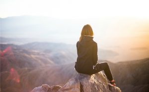 A hiker woman pondering about God’s plan