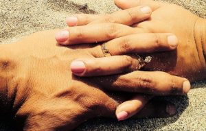 Picture of married couple holding hands.