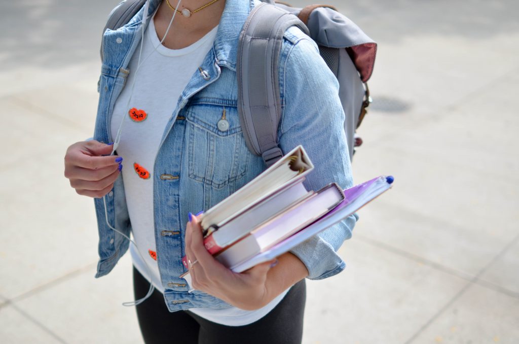 girl with books and backpack