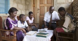 family reading scriptures together during family home evening