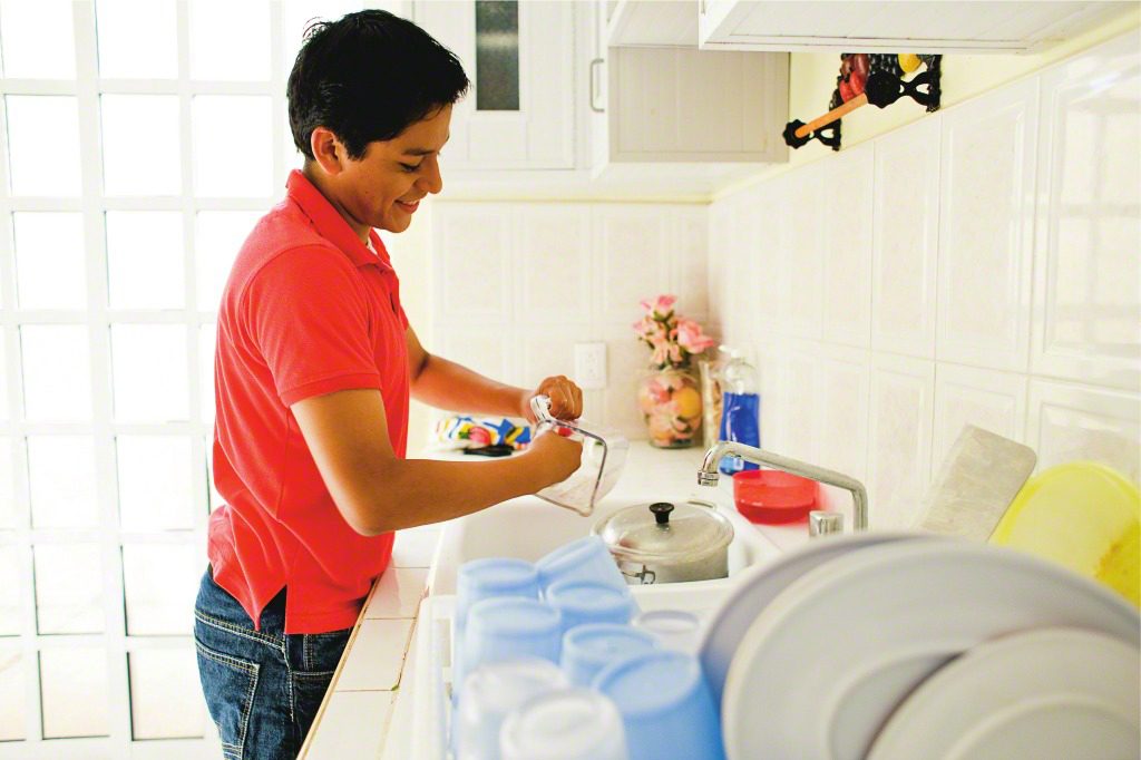 young man washing dishes