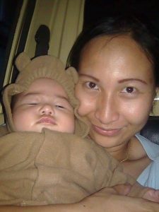baby with bear jacket and mother