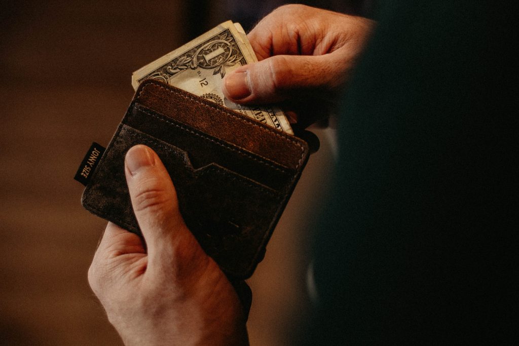 man getting money from wallet