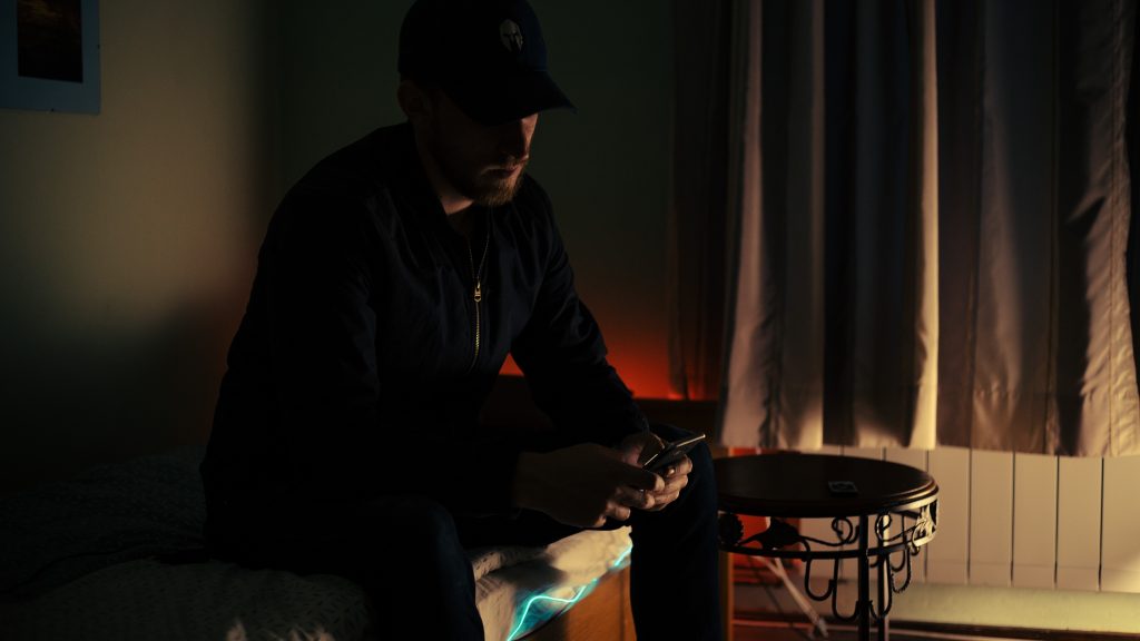 man holding phone in the dark